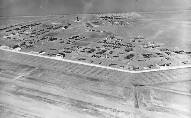 Black-and-white aerial photo of Marfa Army Air Field in 1943: rows of barracks and hangars beside a long runway on open desert
