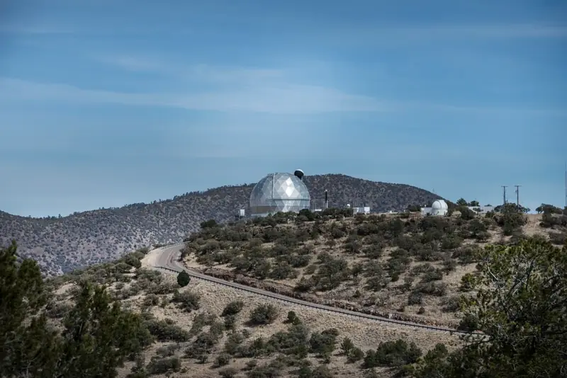 White telescope domes of McDonald Observatory on a mountaintop in the Davis Mountains