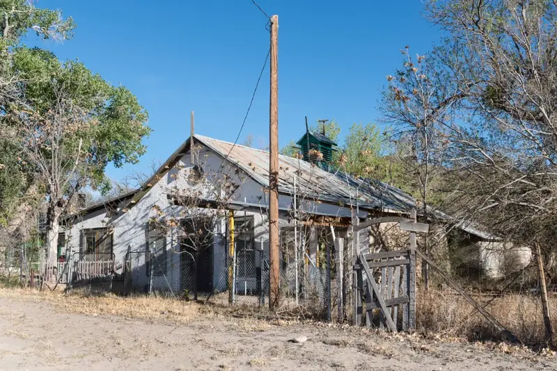 Weathered old buildings and trees in the small community of Shafter
